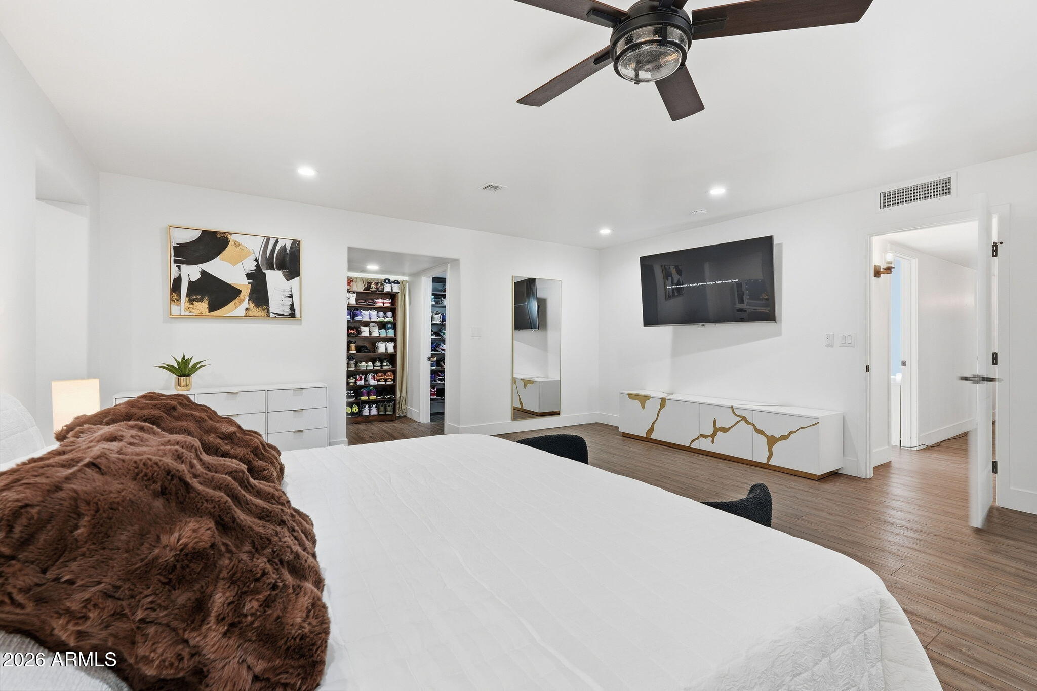5009 East Wethersfield Road Scottsdale, AZ 85254 - Photo 15 of 30 a spacious bedroom with a bed and a flat screen tv