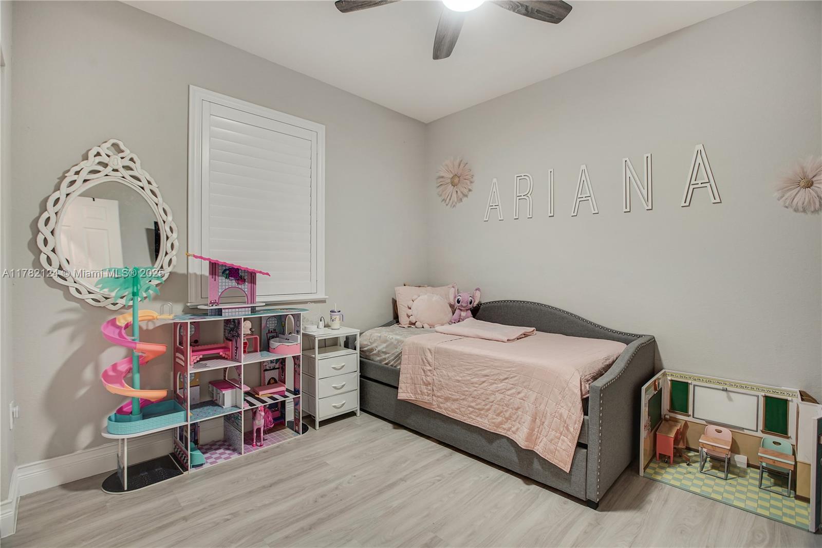 15451 Southwest 173rd Lane Miami, FL 33187 - Photo 11 of 17 a bedroom with a bed and a wooden floor