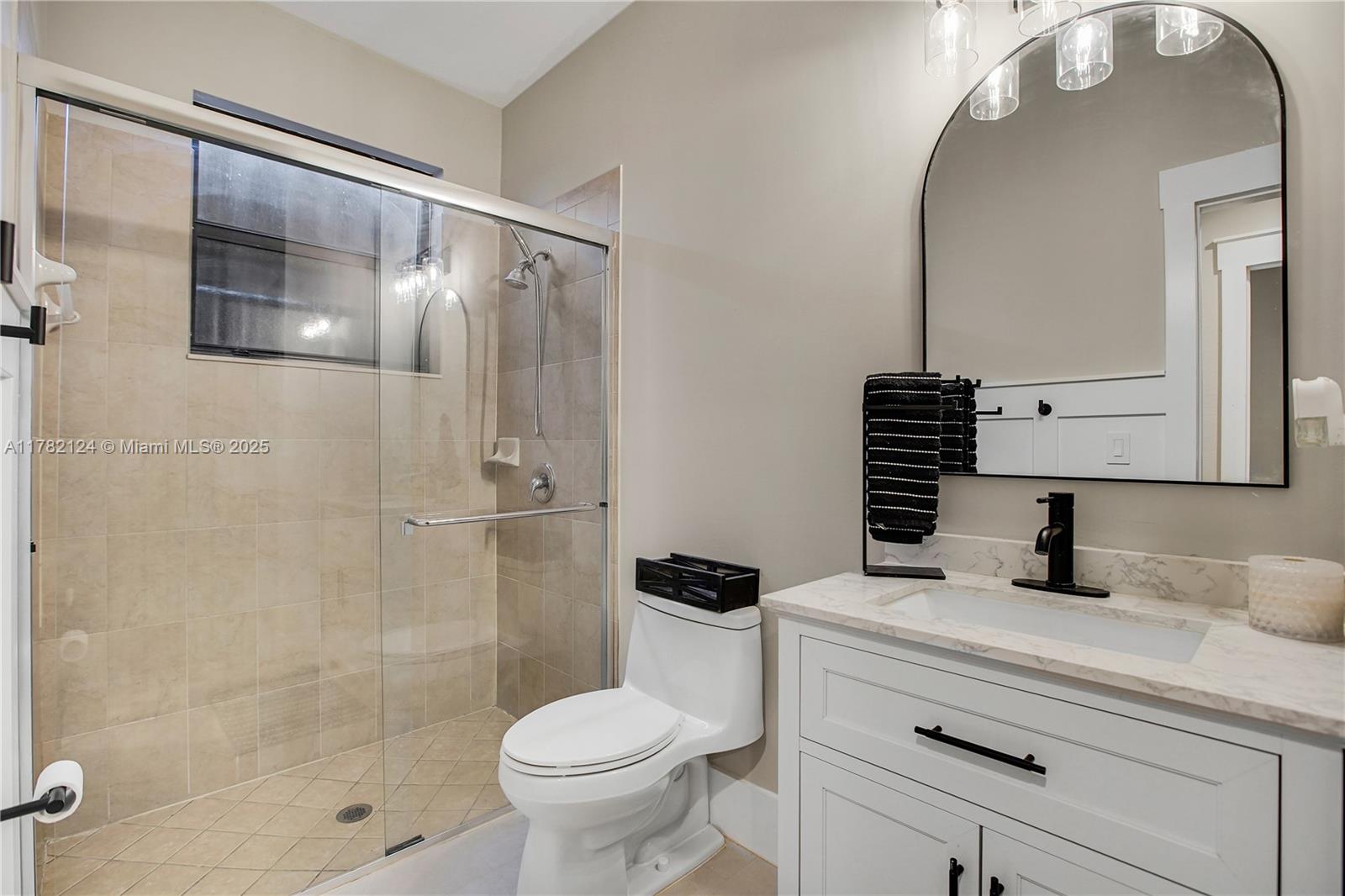15451 Southwest 173rd Lane Miami, FL 33187 - Photo 12 of 17 a bathroom with a sink toilet and shower