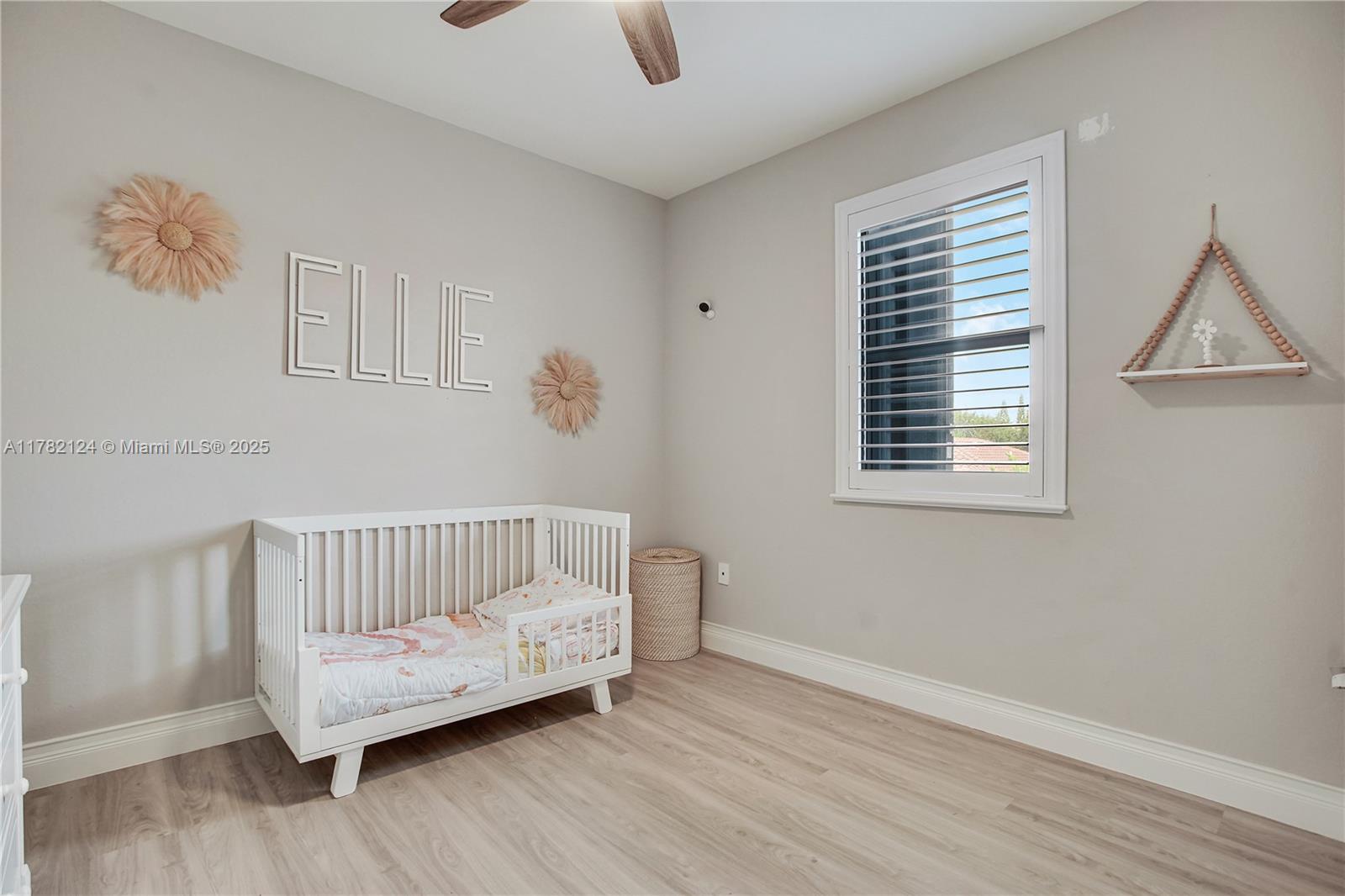 15451 Southwest 173rd Lane Miami, FL 33187 - Photo 13 of 17 a bedroom with a bed and wooden floor