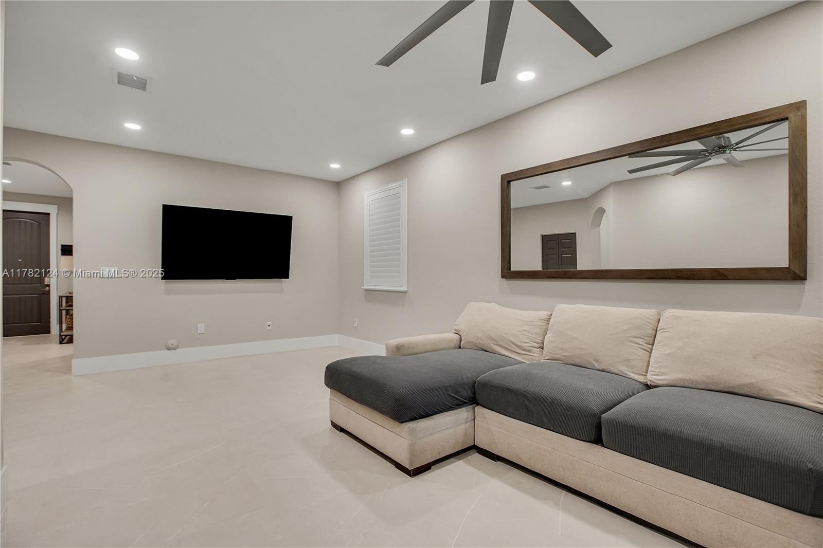 15451 Southwest 173rd Lane Miami, FL 33187 - Photo 3 of 17 a living room with furniture and a flat screen tv
