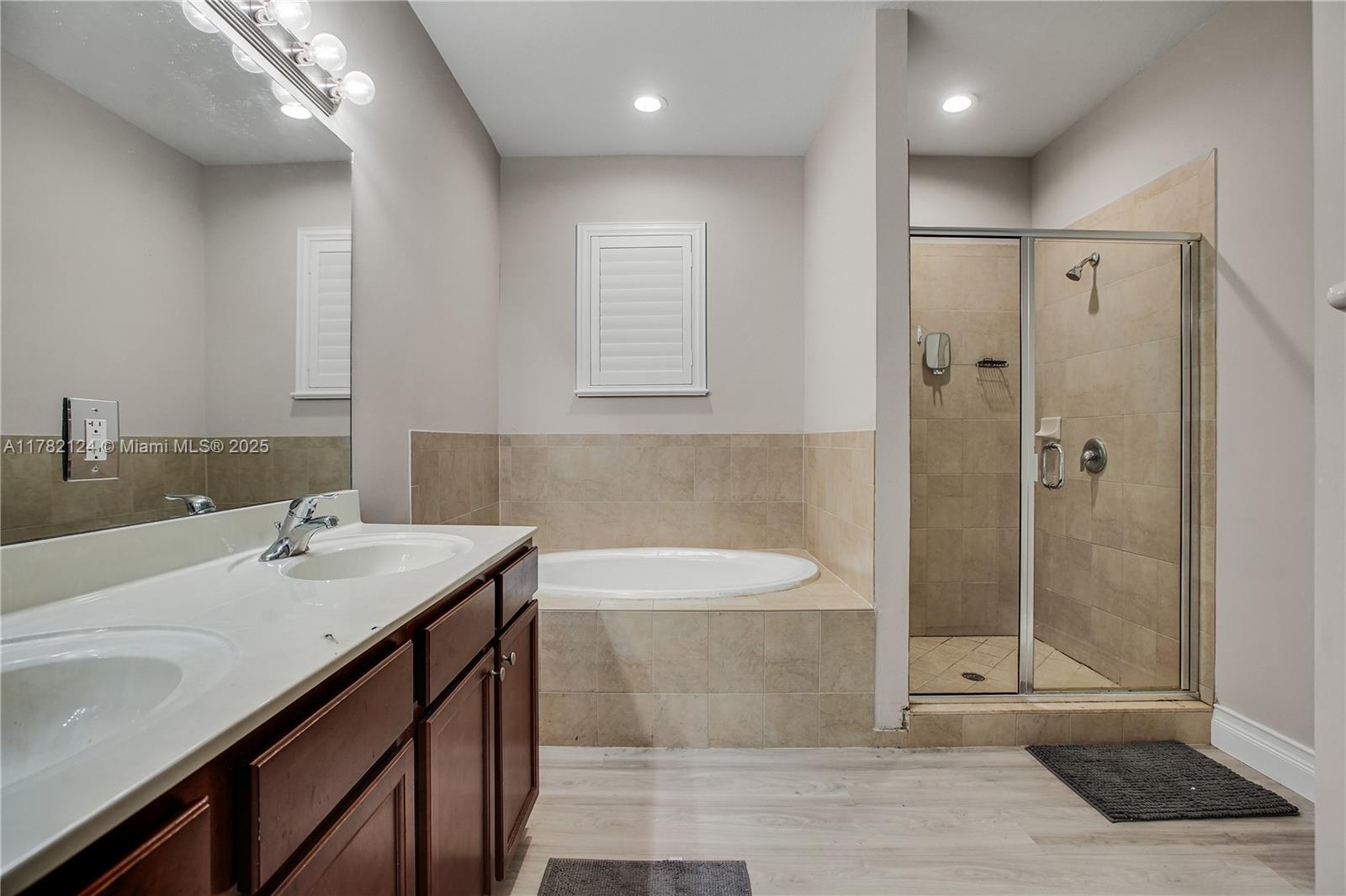 15451 Southwest 173rd Lane Miami, FL 33187 - Photo 8 of 17 a bathroom with a sink a toilet and shower