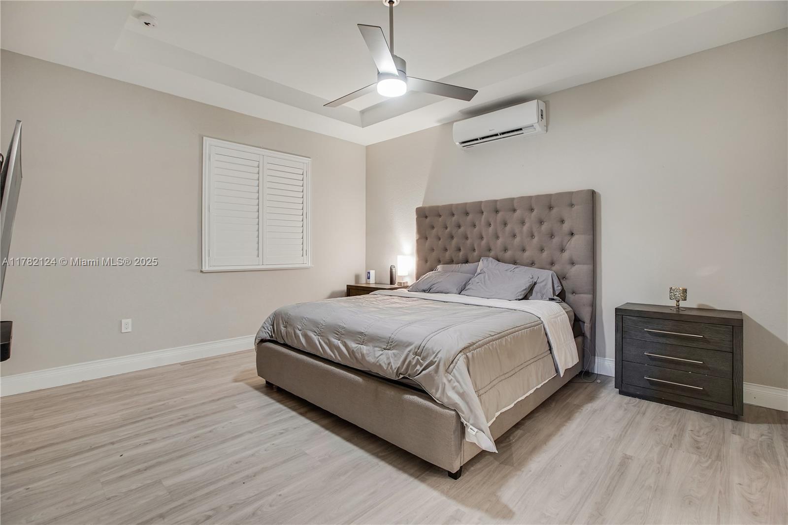 15451 Southwest 173rd Lane Miami, FL 33187 - Photo 9 of 17 a bedroom with a bed and window