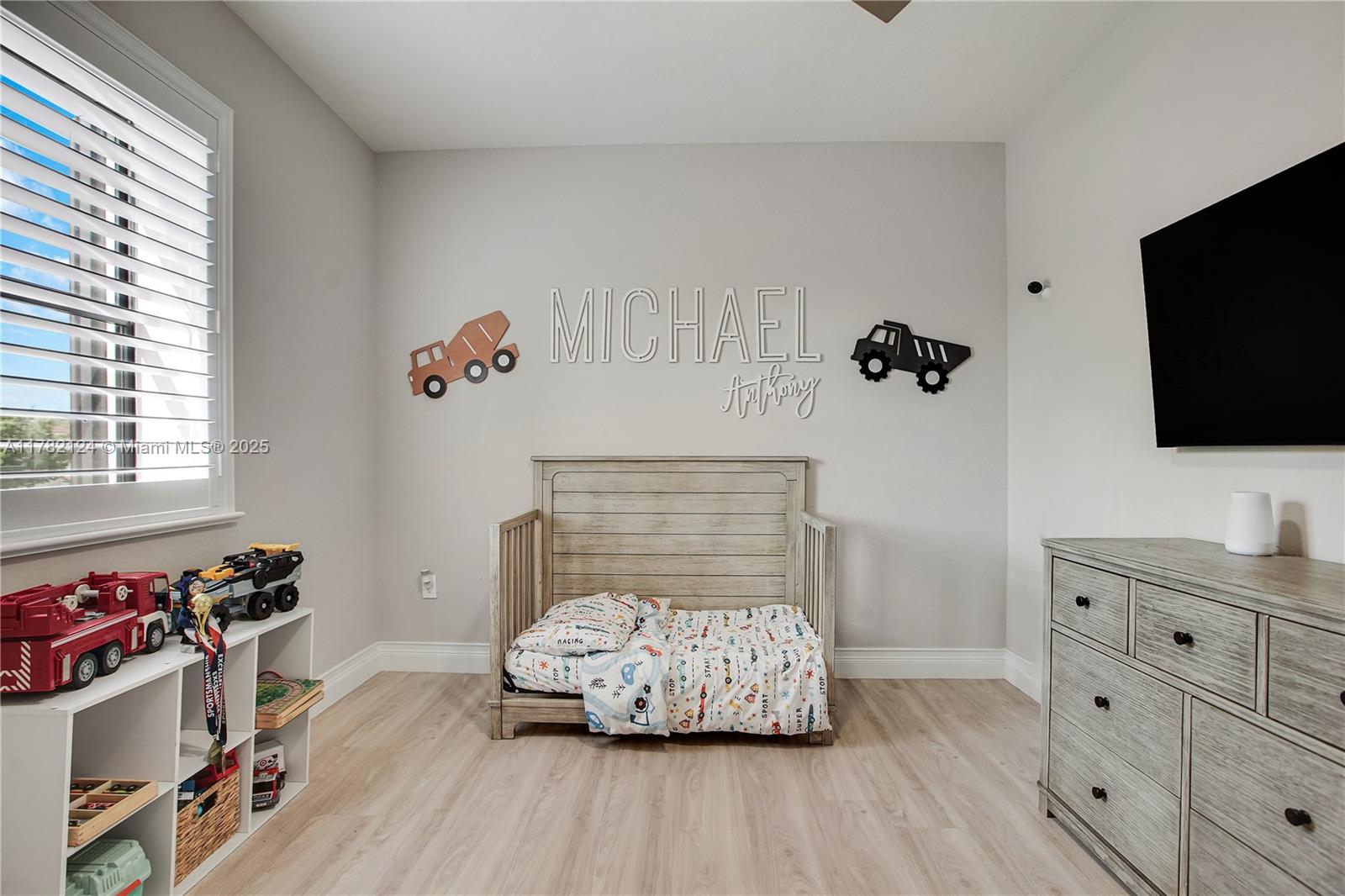 15451 Southwest 173rd Lane Miami, FL 33187 - Photo 10 of 17 a bedroom with a bed and flat tv screen on the dresser