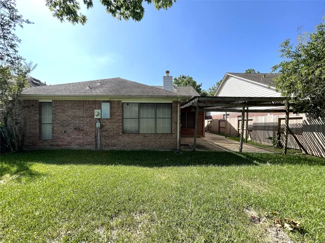 a view of a backyard with a garden and entertaining space