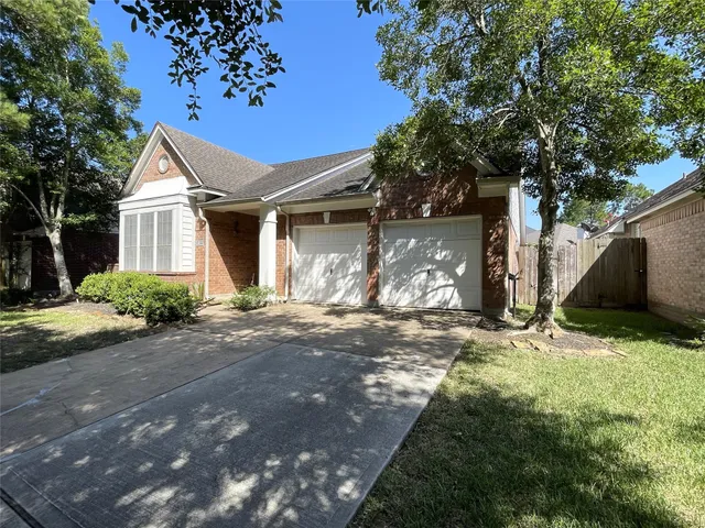 a white house with tree in front of it