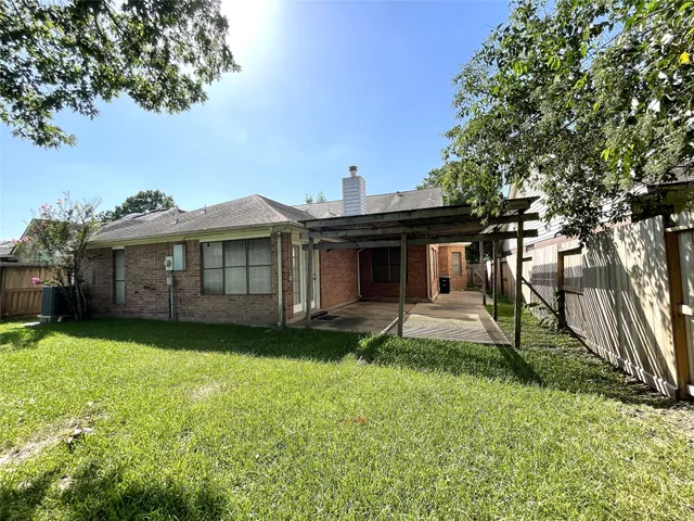 a view of a house with a yard and sitting area