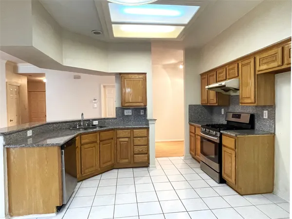 a kitchen with stainless steel appliances granite countertop a sink and cabinets