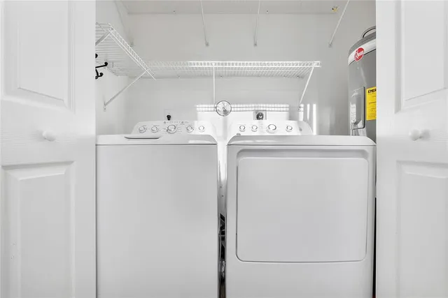 a view of kitchen with sink and refrigerator