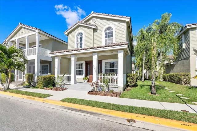 a view of a house with a swimming pool and a lawn chairs next to a yard