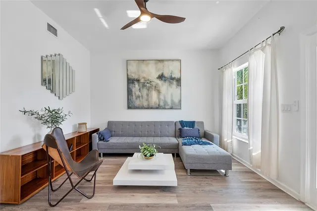 a living room with furniture and a potted plant