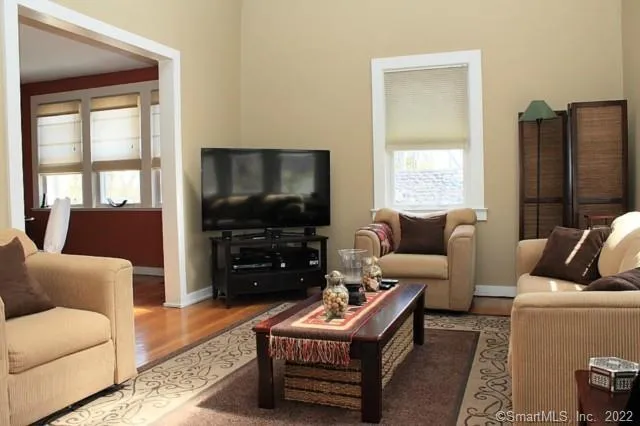 a living room with furniture and a flat screen tv