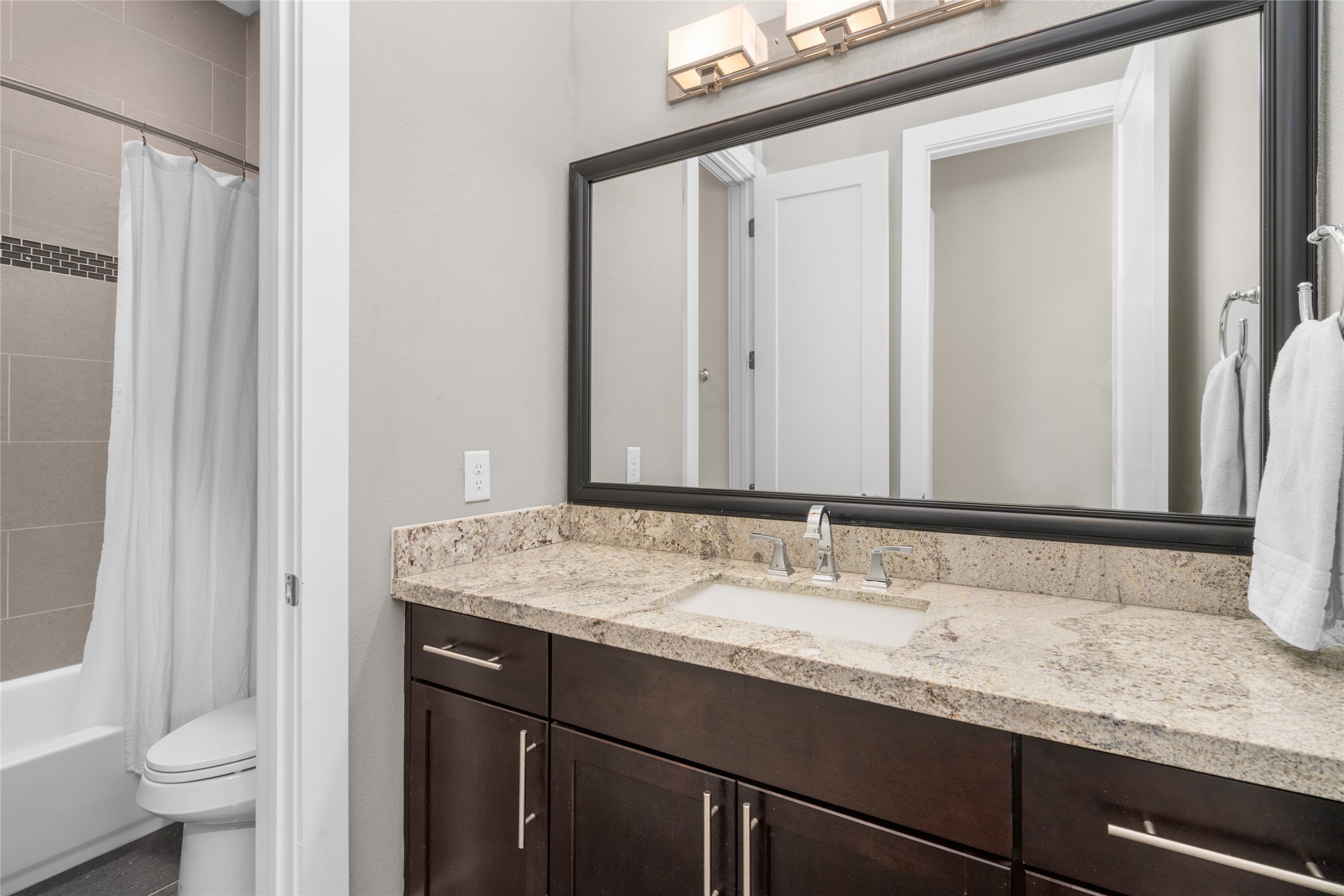 1605 Knox Street, Unit B Houston, TX 77007 - Photo 21 of 28 a bathroom with a granite countertop sink and a mirror