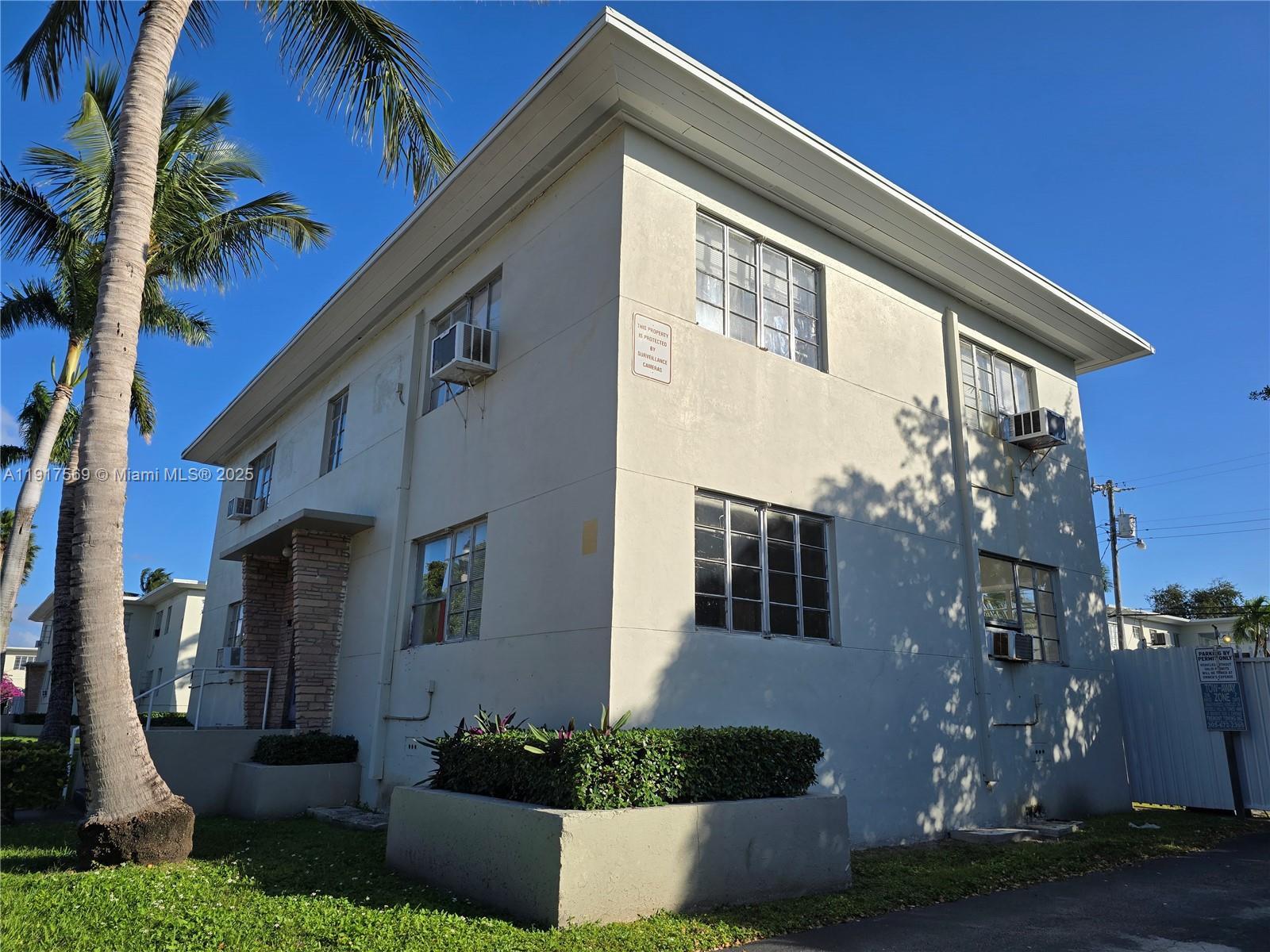 660 84th Street, Unit 39 Miami Beach, FL 33141 - Photo 1 of 17 a front view of a house with a yard