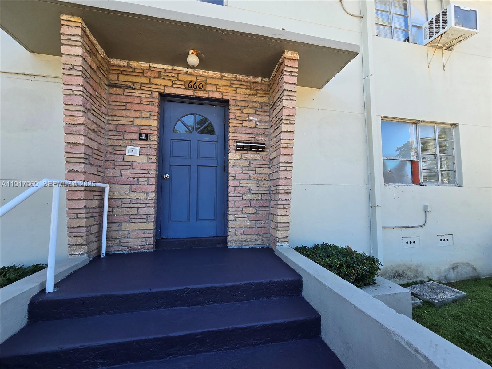 660 84th Street, Unit 39 Miami Beach, FL 33141 - Photo 14 of 17 a view of front door of house with stairs