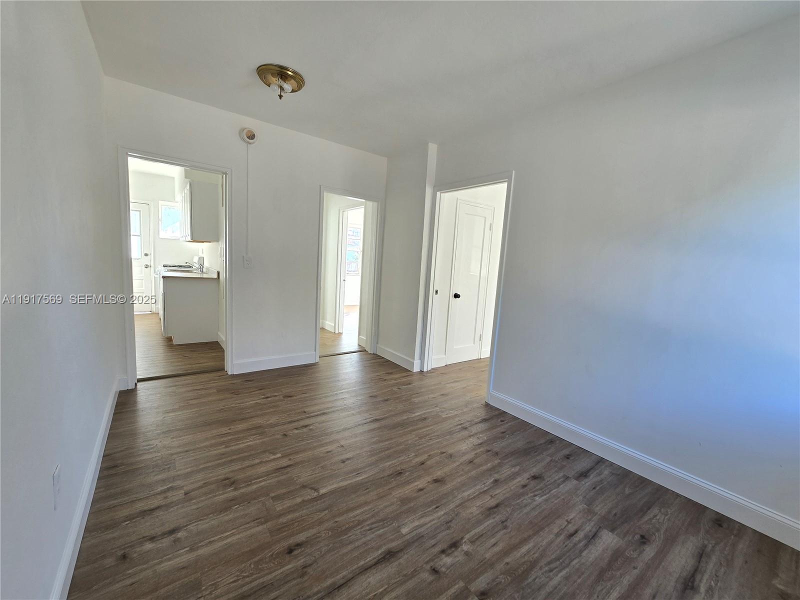 660 84th Street, Unit 39 Miami Beach, FL 33141 - Photo 7 of 17 a view of a room with wooden floor and windows