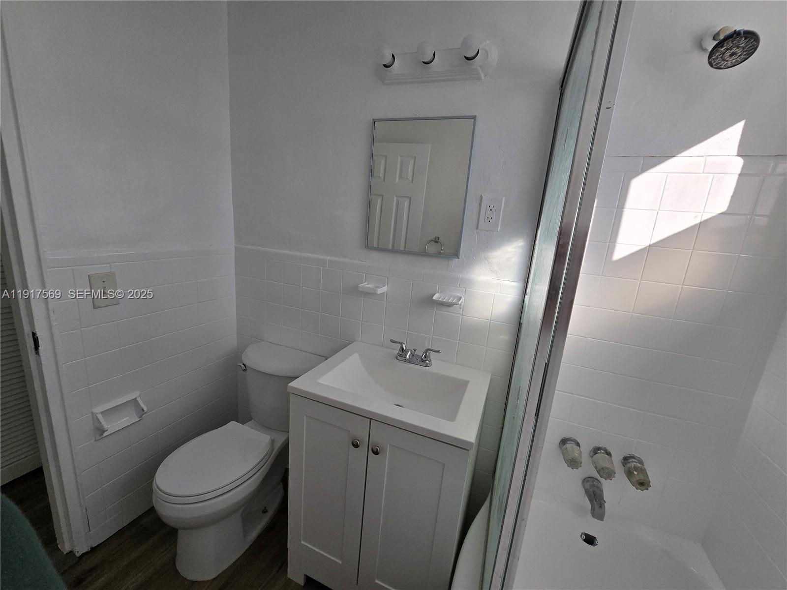 660 84th Street, Unit 39 Miami Beach, FL 33141 - Photo 9 of 17 a bathroom with a sink a toilet and shower
