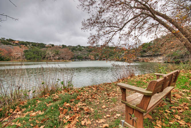 a view of a lake with a bench next to a lake