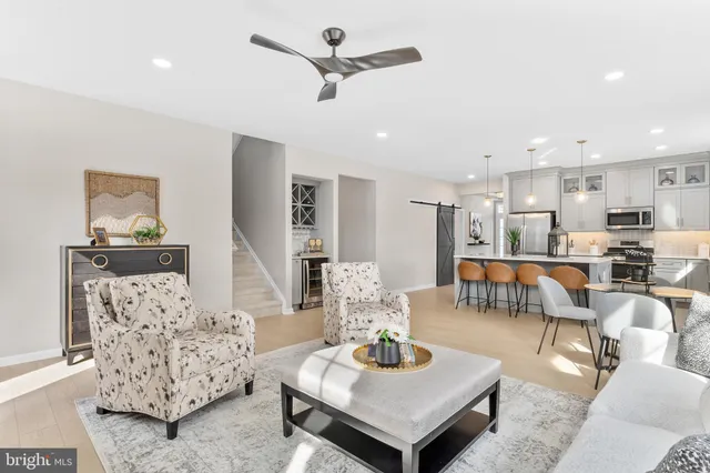 a living room with furniture and kitchen view