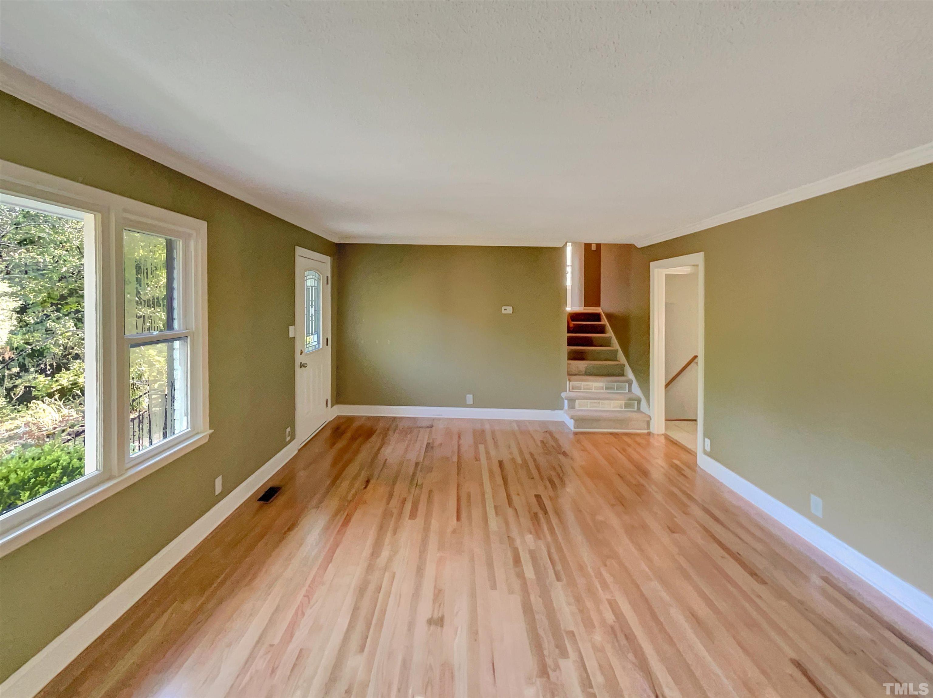 2628 Ramsey Road Raleigh, NC 27604 - Photo 5 of 17 a view of empty room with wooden floor and fan