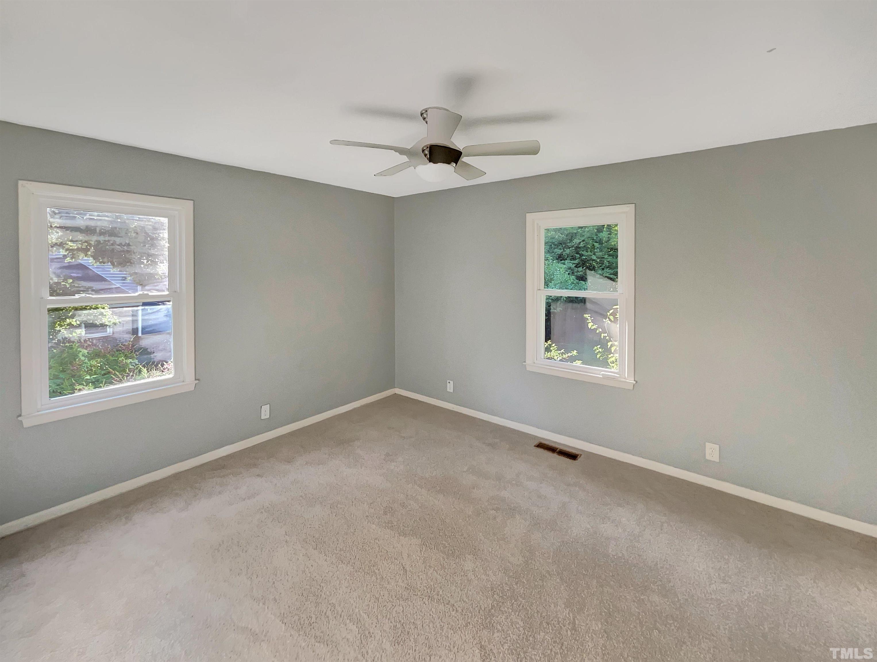 2628 Ramsey Road Raleigh, NC 27604 - Photo 9 of 17 an empty room with a window and a ceiling fan