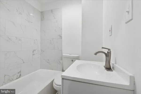 a kitchen with a refrigerator sink and cabinets