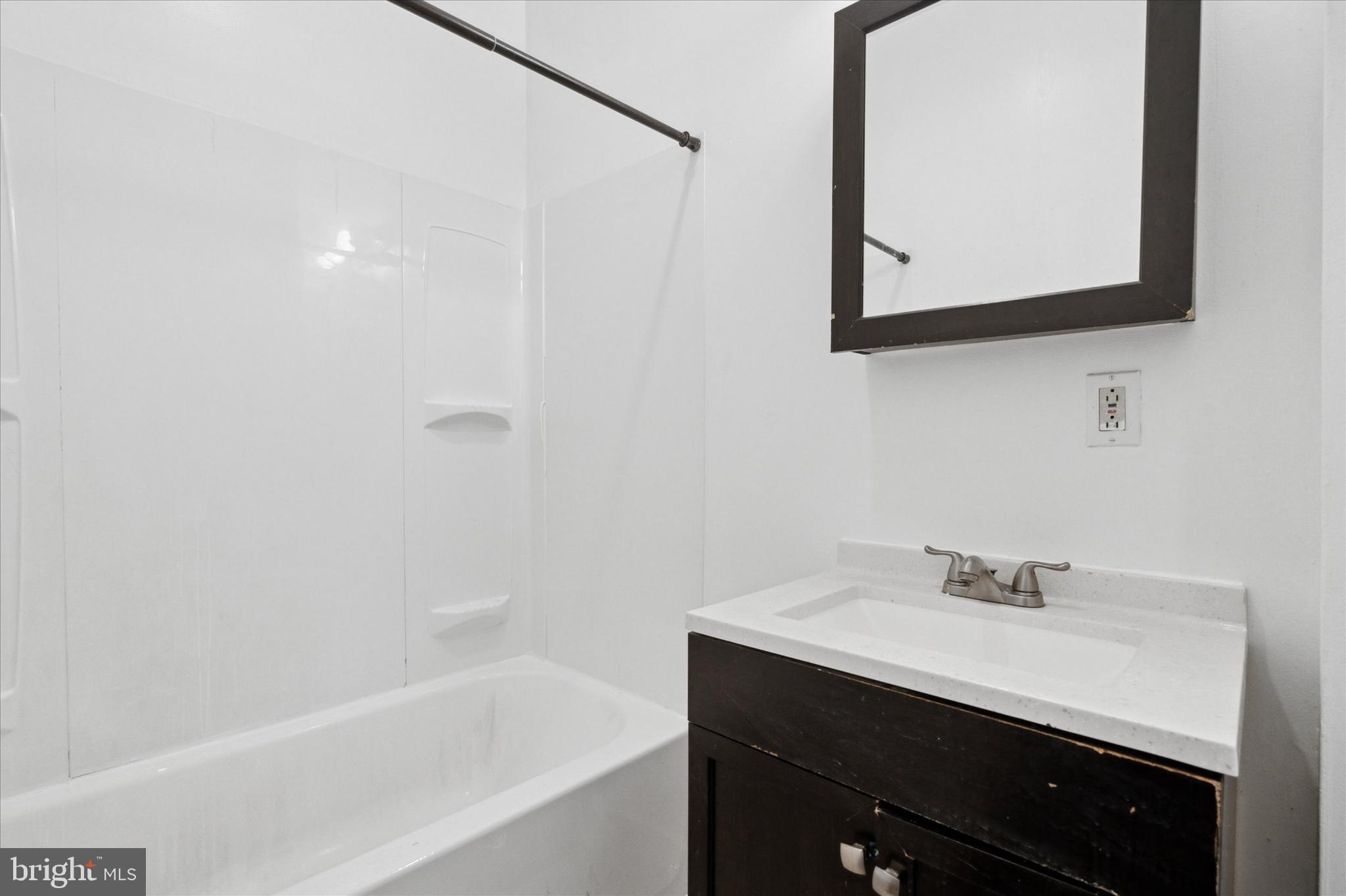 1501 Reed Street Philadelphia, PA 19146 - Photo 8 of 17 a bathroom with a sink a mirror and a bathtub