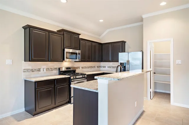 a kitchen with stainless steel appliances a stove sink and refrigerator