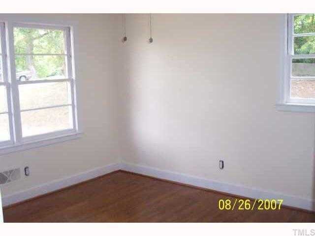 4305 James Road Raleigh, NC 27616 - Photo 4 of 5 a view of an empty room with wooden floor and a window