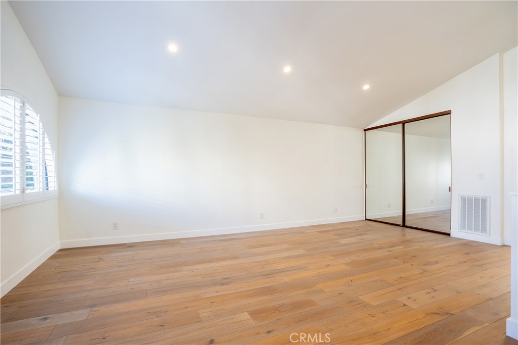 10926 Bluffside Drive, Unit 9 Studio City, CA 91604 - Photo 24 of 43 a view of an empty room with wooden floor and a window