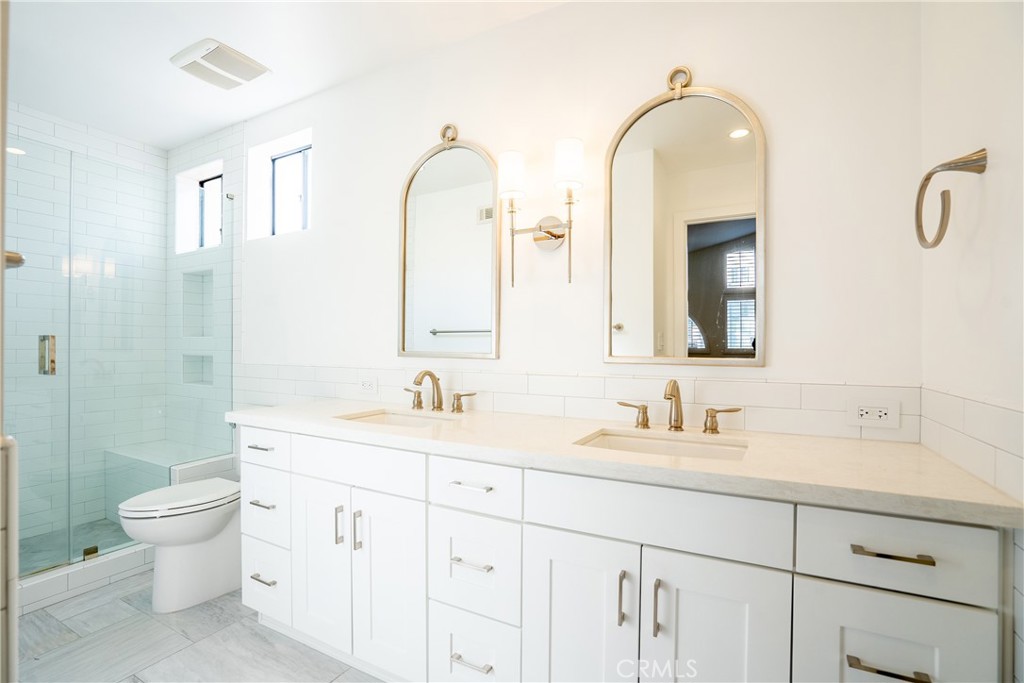 10926 Bluffside Drive, Unit 9 Studio City, CA 91604 - Photo 25 of 43 a bathroom with a double vanity sink toilet and a mirror