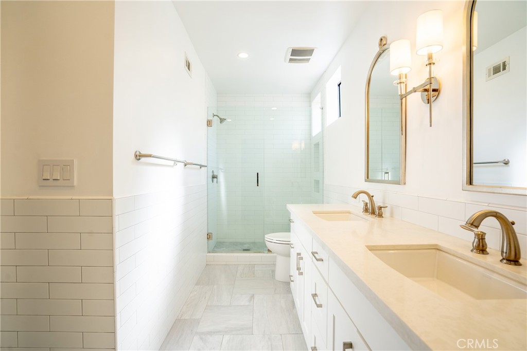 10926 Bluffside Drive, Unit 9 Studio City, CA 91604 - Photo 26 of 43 a bathroom with a granite countertop sink a mirror and a shower