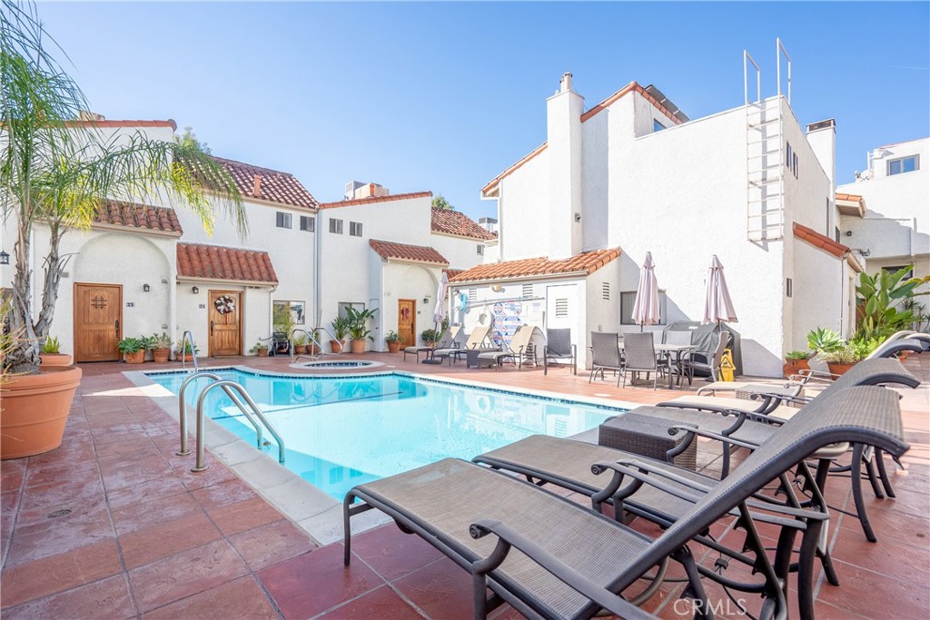 10926 Bluffside Drive, Unit 9 Studio City, CA 91604 - Photo 33 of 43 a view of a patio with swimming pool table and chairs