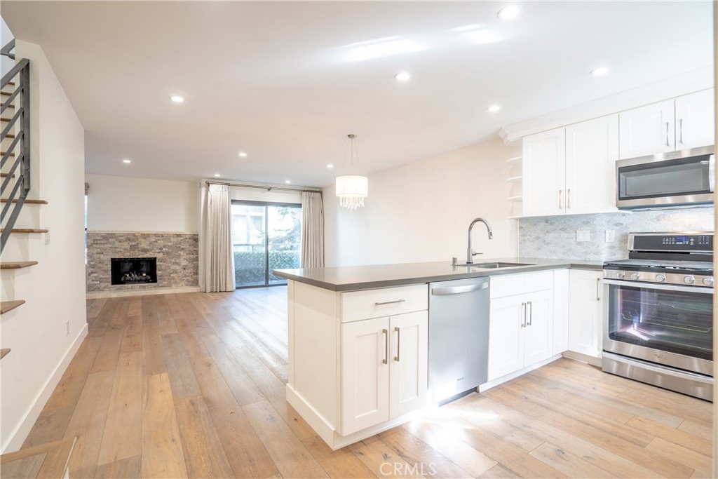 10926 Bluffside Drive, Unit 9 Studio City, CA 91604 - Photo 6 of 43 a kitchen with stainless steel appliances granite countertop a stove top oven a sink and a oven