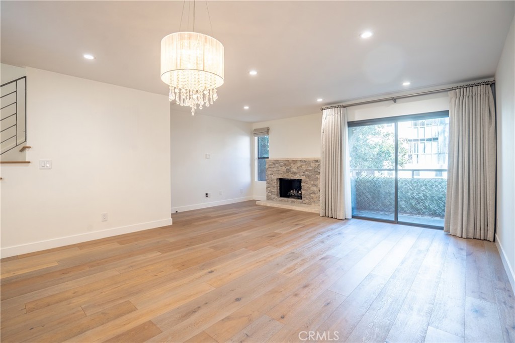 10926 Bluffside Drive, Unit 9 Studio City, CA 91604 - Photo 10 of 43 an empty room with wooden floor chandelier and windows