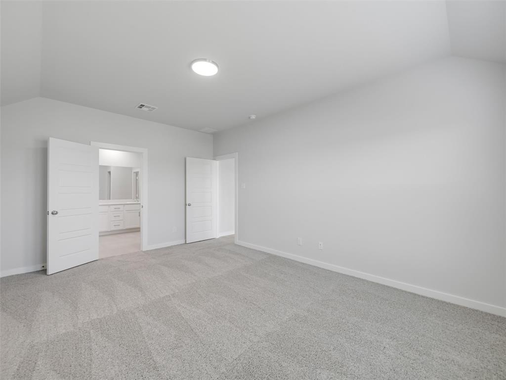 1136 Del Rio Drive Lavon, TX 75166 - Photo 15 of 30 Spacious bedroom featuring neutral wall finishes, recessed ceiling lighting, and plush carpet flooring
