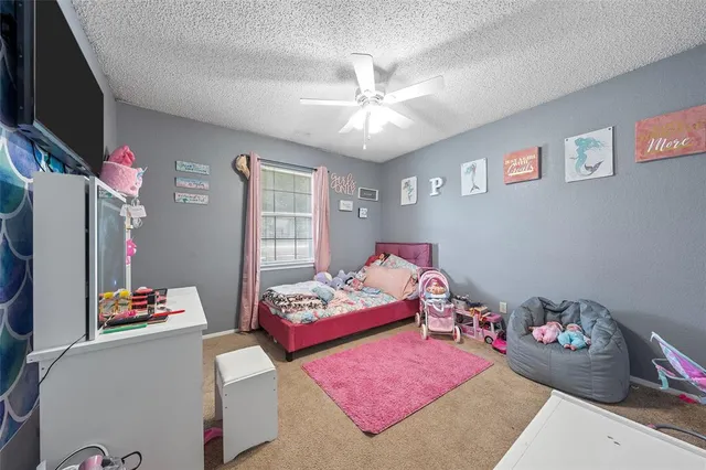 a bedroom with furniture and a flat screen tv