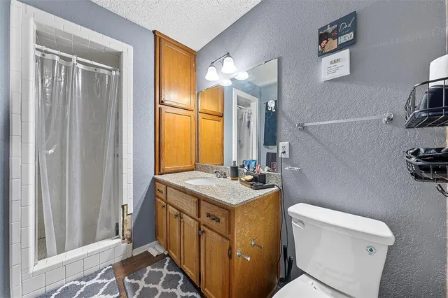 a bathroom with a sink a toilet and a mirror