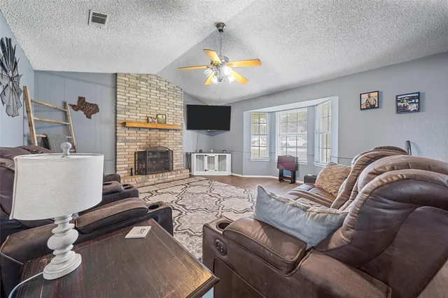a living room with furniture and a fireplace
