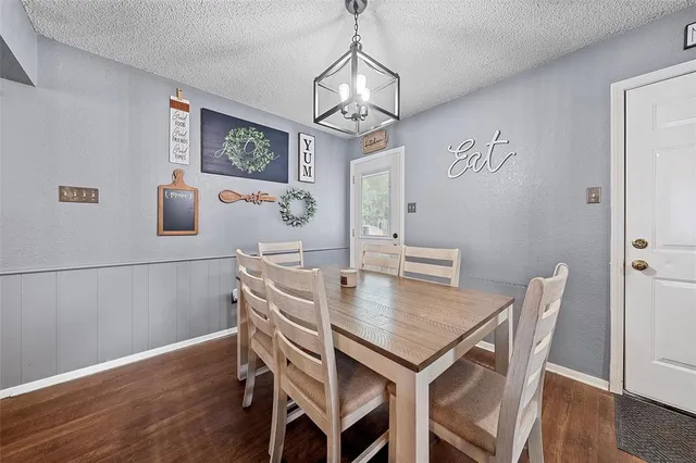 a view of a dining room with furniture wooden floor and a chandelier