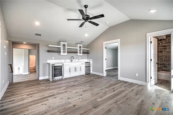 a view of a kitchen with a stove cabinets and wooden floor