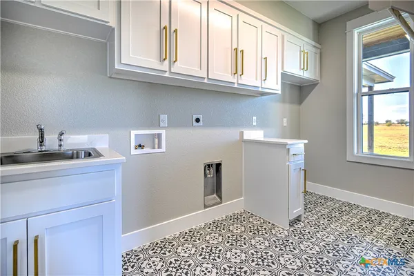 a kitchen with a stove a sink and a window