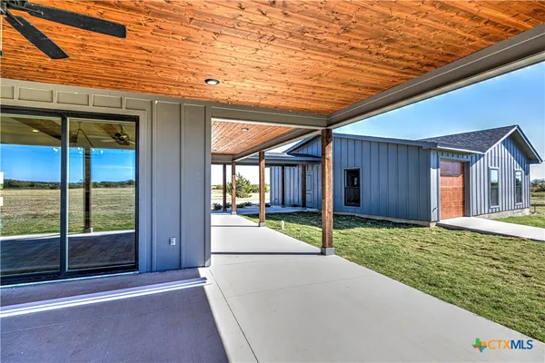 a house with yard and outdoor seating