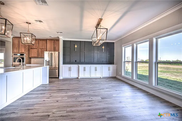 a view of a kitchen with a sink and wooden floor