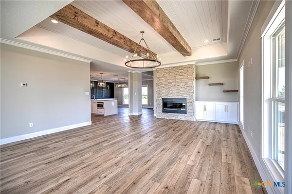 wooden floor in an empty room with a fireplace