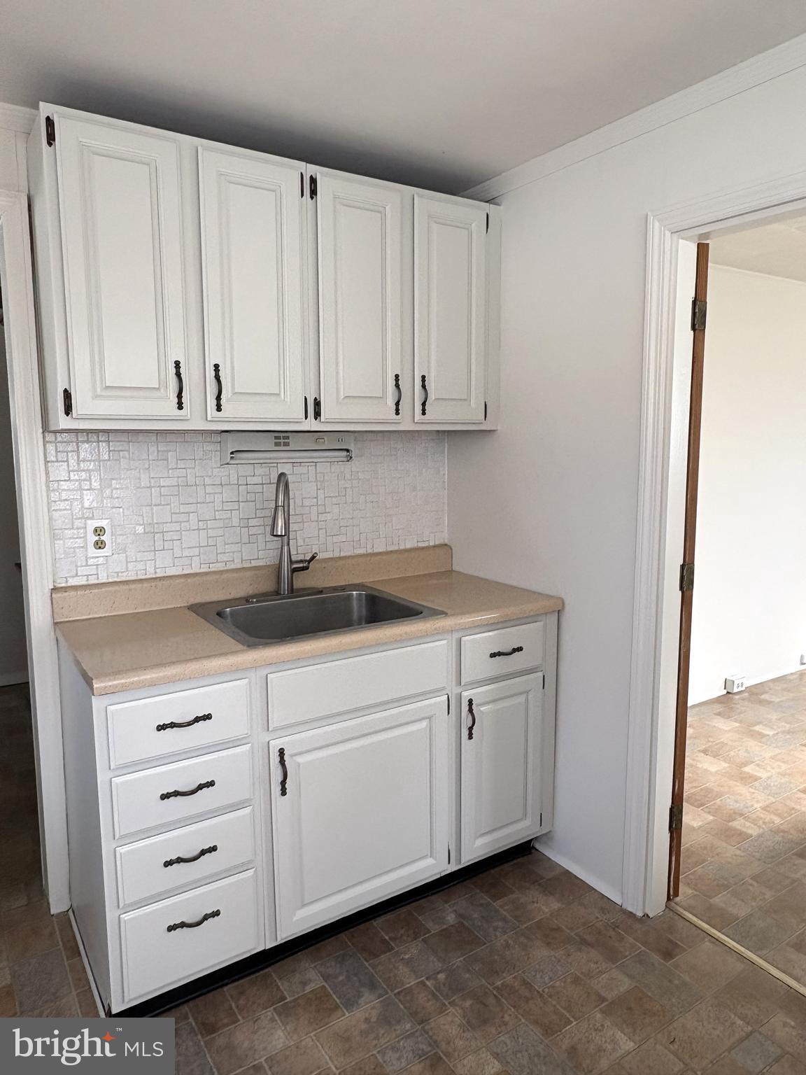 115 Compass Road Baltimore, MD 21220 - Photo 11 of 13 a kitchen with cabinets appliances and a sink