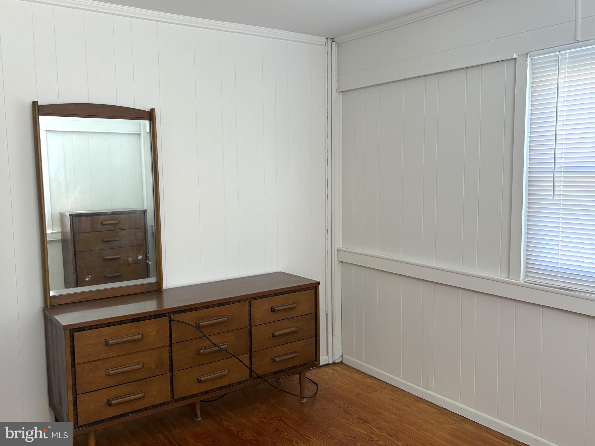 115 Compass Road Baltimore, MD 21220 - Photo 13 of 13 a view of a dresser with wooden floor