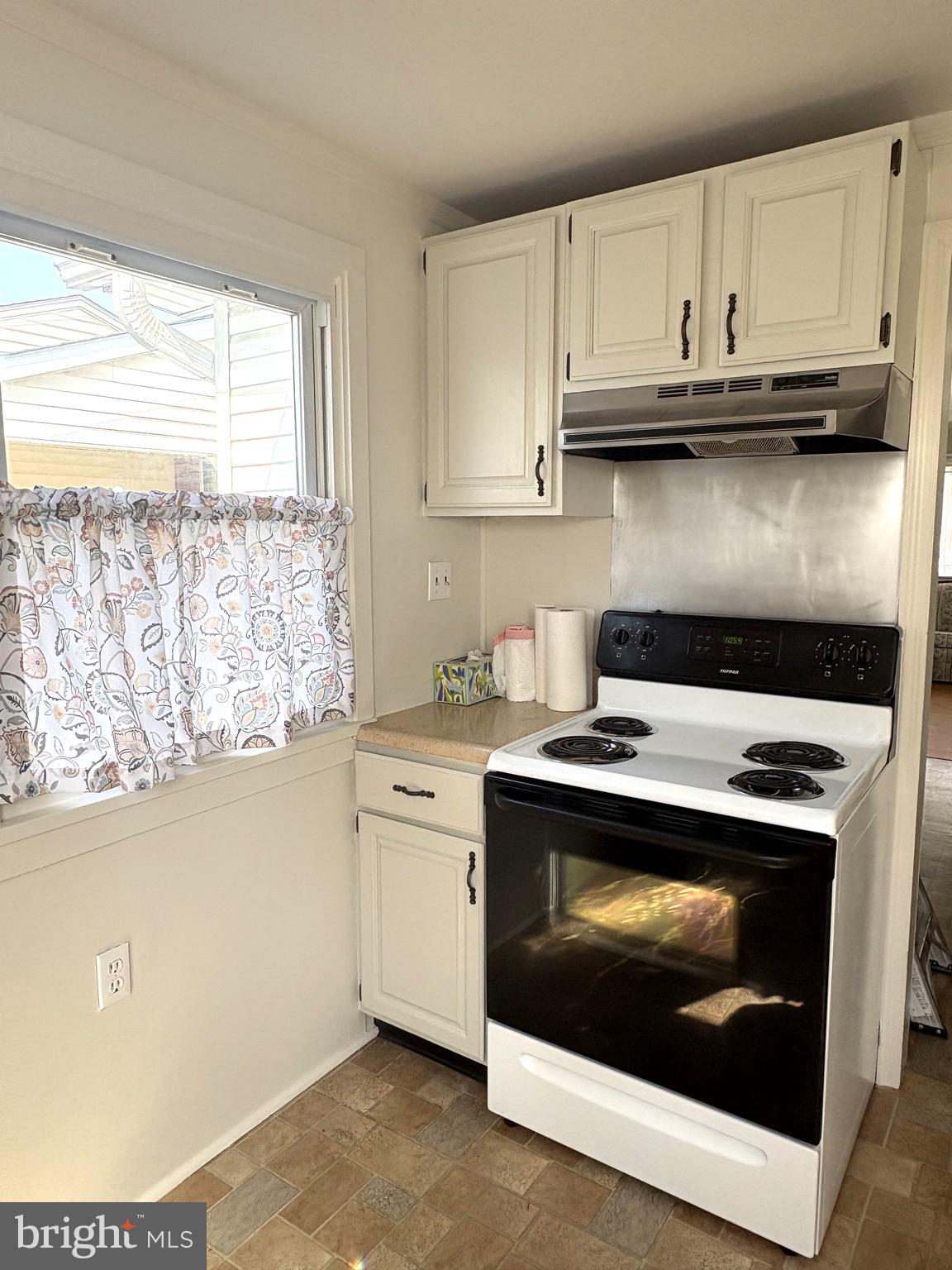 115 Compass Road Baltimore, MD 21220 - Photo 10 of 13 a stove top oven sitting inside of a kitchen