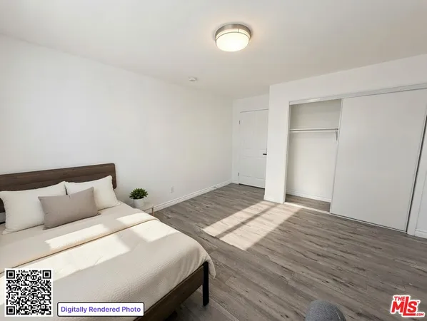 a bedroom with a bed and a night stand