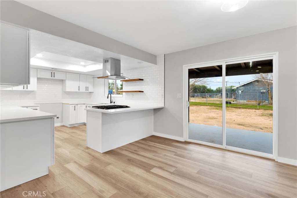 12532 Sholic Road Apple Valley, CA 92308 - Photo 14 of 41 a kitchen with a stove a refrigerator and white cabinets